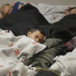 AP photo used in Tampa Bay Times report on 12/22/14 shows "Young detainees sleep in a holding cell on June 18, 2014, at a U.S. Customs and Border Protection processing facility in Brownsville,Texas." 