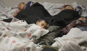 AP photo used in Tampa Bay Times report on 12/22/14 shows "Young detainees sleep in a holding cell on June 18, 2014, at a U.S. Customs and Border Protection processing facility in Brownsville,Texas." 