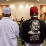 Photo of Michael Brown Sr., right, at a City Council meeting in Ferguson, Mo., from a New York Times report, 2/10/16, "Department of Justice Sues Ferguson, Which Reversed Course on Agreement"
